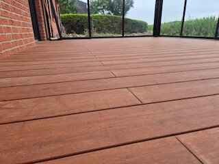 Detail eines Terrassenbodens aus braunen Hartholzdielen mit gleichmäßigen Fugen
